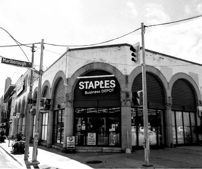 The arched facade with a Staples storefront