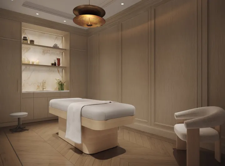 Treatment room with a massage table and panelled walls